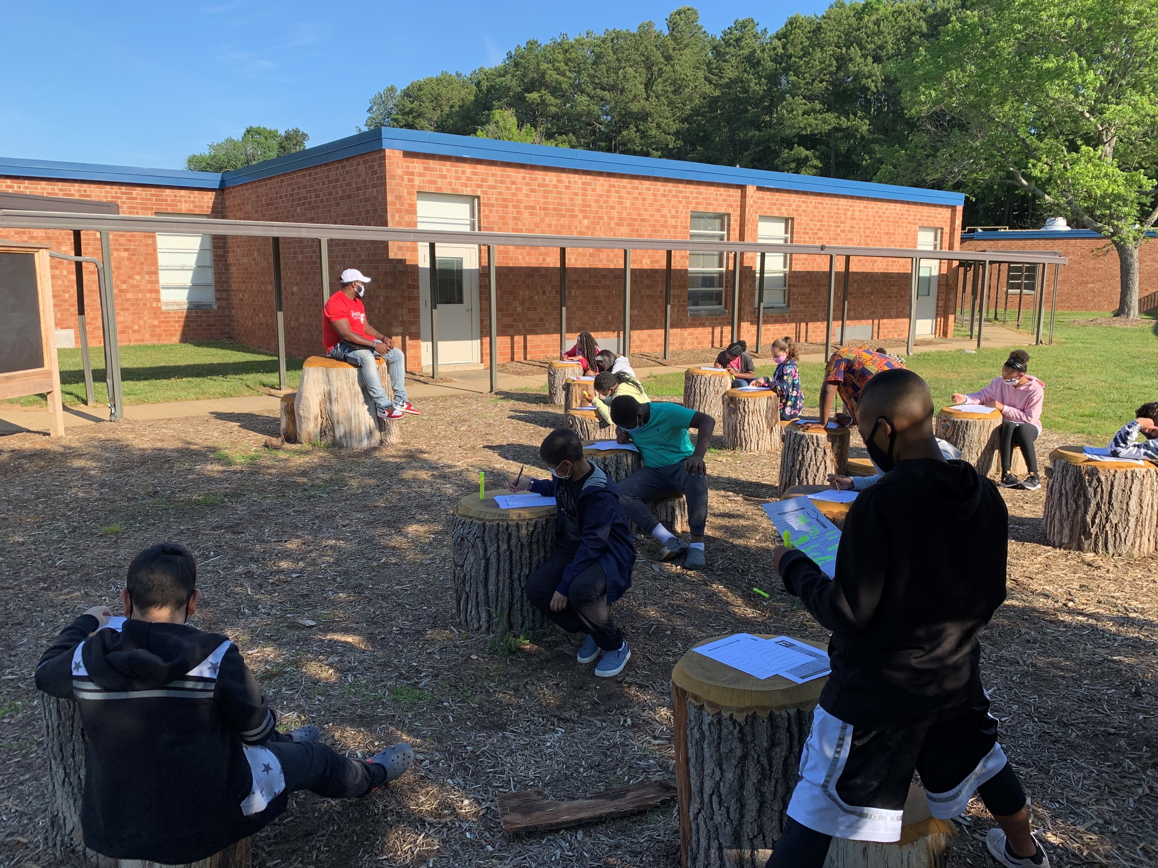 caption: Students at Foust Elementary School in Greensboro, North Carolina gather in an outdoor classroom.
