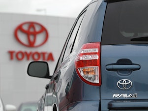 caption: A Toyota RAV4 sits on the sales lot at a Toyota dealership in February 2011 in Oakland, Calif.
