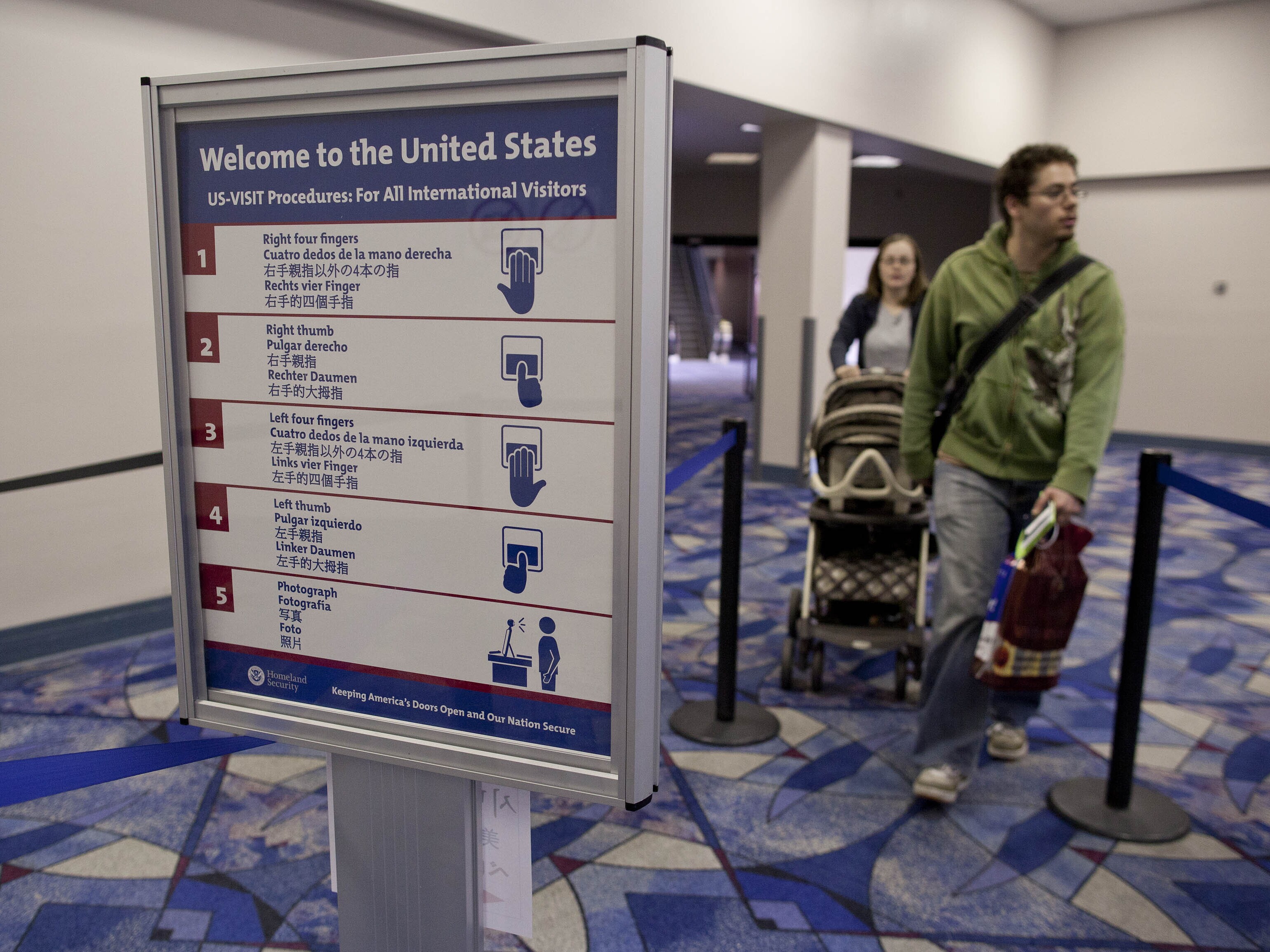 caption: Passengers from an international flight enter customs and immigration control at McCarran International Airport (now known as Harry Reid International Airport) in 2011. The Department of Homeland Security is proposing collecting social media information from tourists visiting the U.S. from countries that don't require a visa.