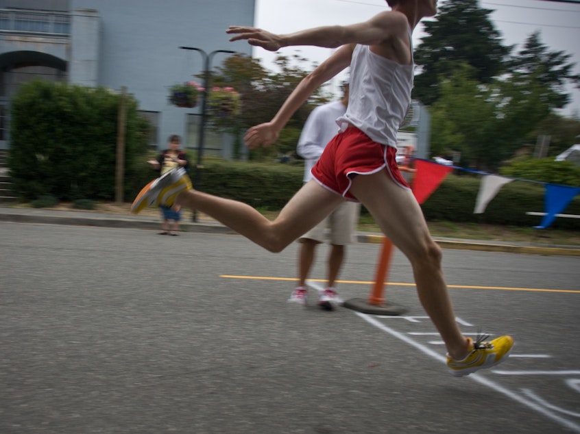 A runner crosses the finish line.