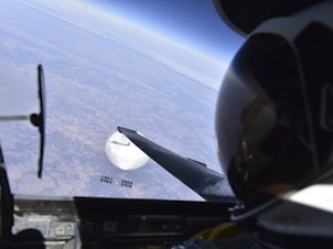 caption: A U.S. Air Force pilot looked down at the suspected Chinese surveillance balloon as it hovered over the Central Continental United States on Feb. 3. The pair was flying over Bellflower, Mo.