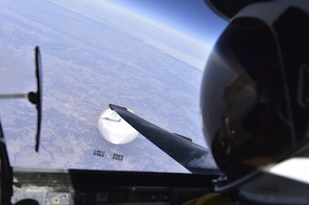 caption: A U.S. Air Force pilot looked down at the suspected Chinese surveillance balloon as it hovered over the Central Continental United States on Feb. 3. The pair was flying over Bellflower, Mo.