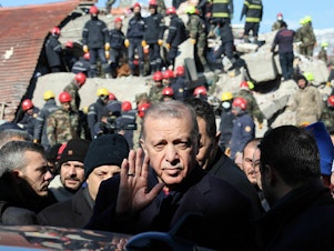 caption: Turkish President Recep Tayyip Erdogan tours the site of destroyed buildings during his visit to the city of Kahramanmaras, in southeast Turkey, on Wednesday, two days after the severe earthquake that hit the region.
