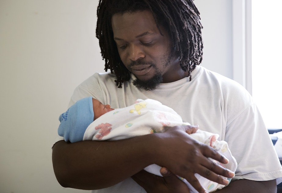 caption: Carl Lindley holds his newborn son, Elijah Dayshawn Lindley, on Thursday, August 31, 2017, at Swedish First Hill Birth Center in Seattle. 