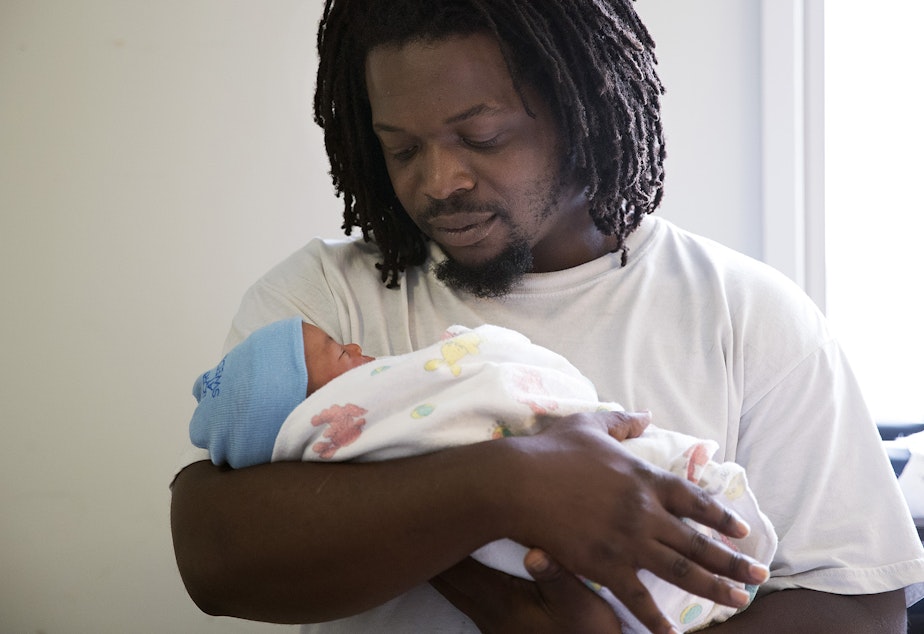caption: Carl Lindley holds his newborn son, Elijah Dayshawn Lindley, on Thursday, August 31, 2017, at Swedish First Hill Birth Center in Seattle.
