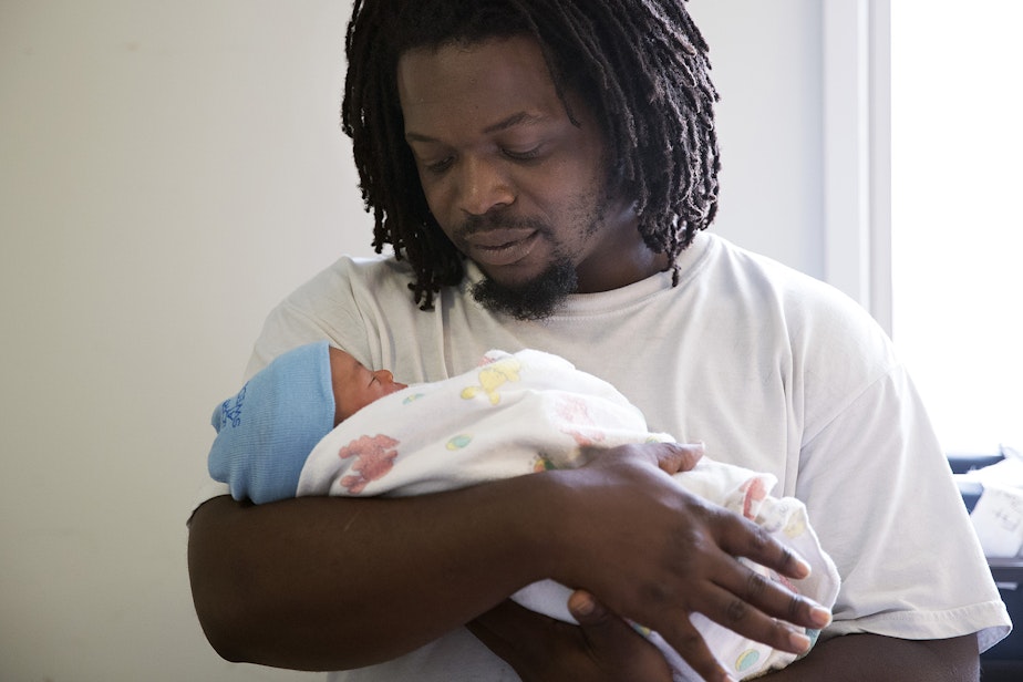 caption: Carl Lindley holds his newborn son, Elijah Dayshawn Lindley, on Thursday, August 31, 2017, at Swedish First Hill Birth Center in Seattle. 