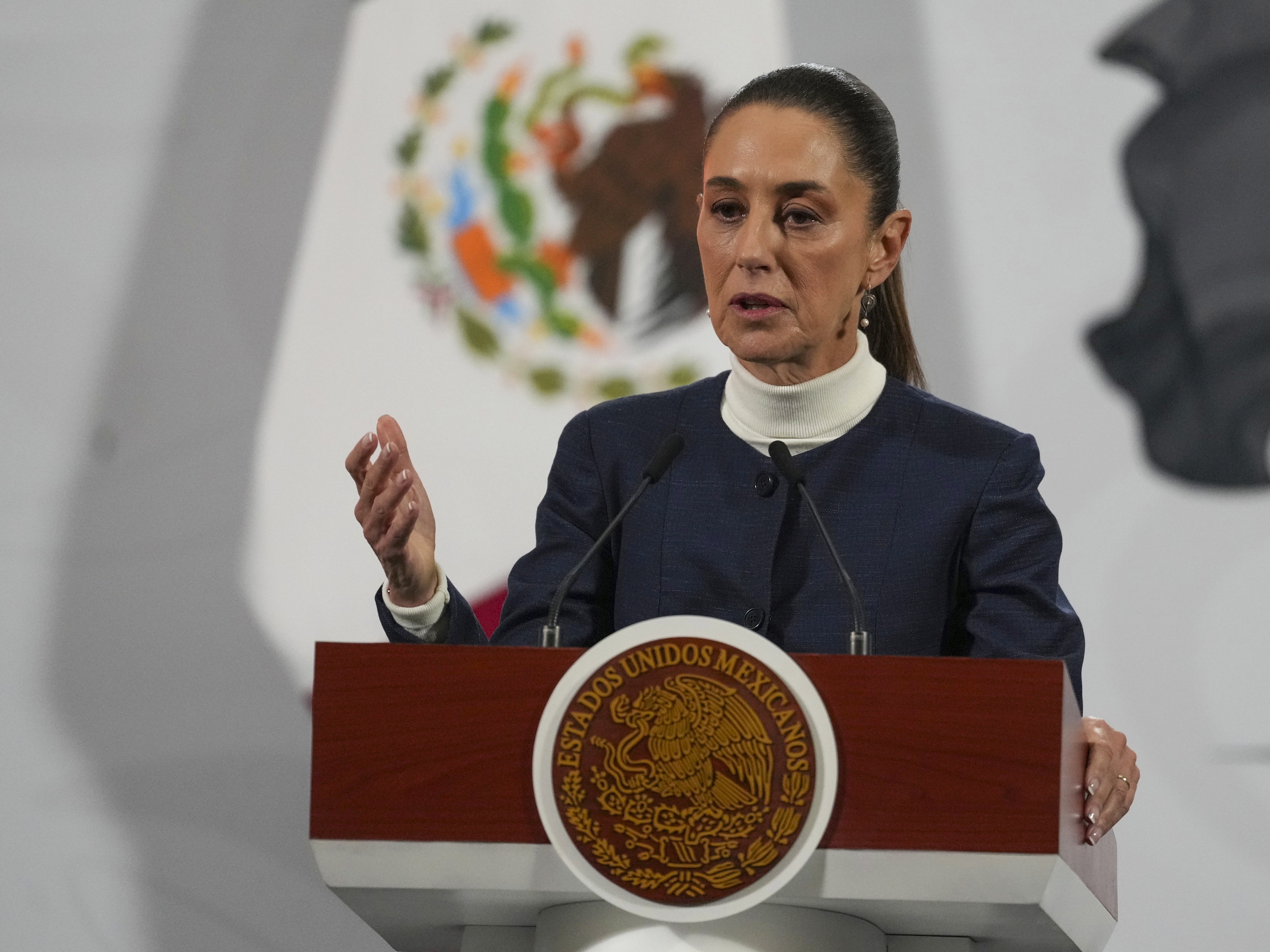 caption: Mexican President Claudia Sheinbaum gives her daily morning press conference at the National Palace in Mexico City, Monday.