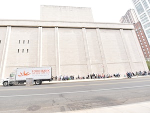 caption: Food Bank For New York City hosts a pop-up food pantry during Hunger Action Month at Lincoln Center on September 24, 2020.