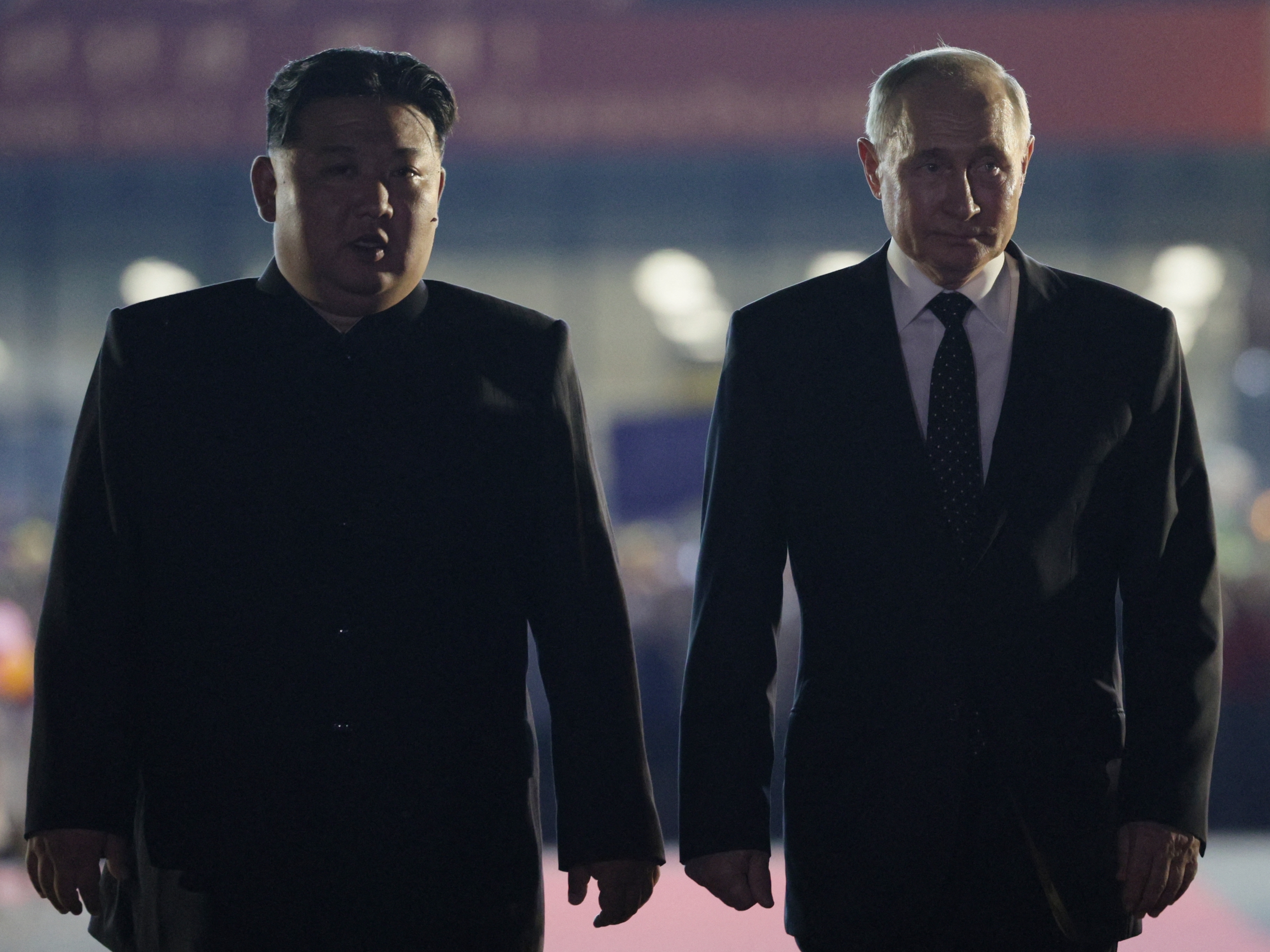caption: In this pool photograph distributed by the Russian state agency Sputnik, Russian President Vladimir Putin, right, and North Korean leader Kim Jong Un walk during a farewell ceremony upon Putin's departure at the Sunan International Airport in Pyongyang on June 19.