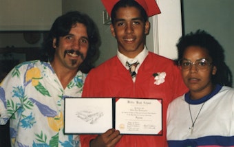 caption: Storyteller Silas Lindenstein, center, with his parents at his high school graduation in Massachusetts. 