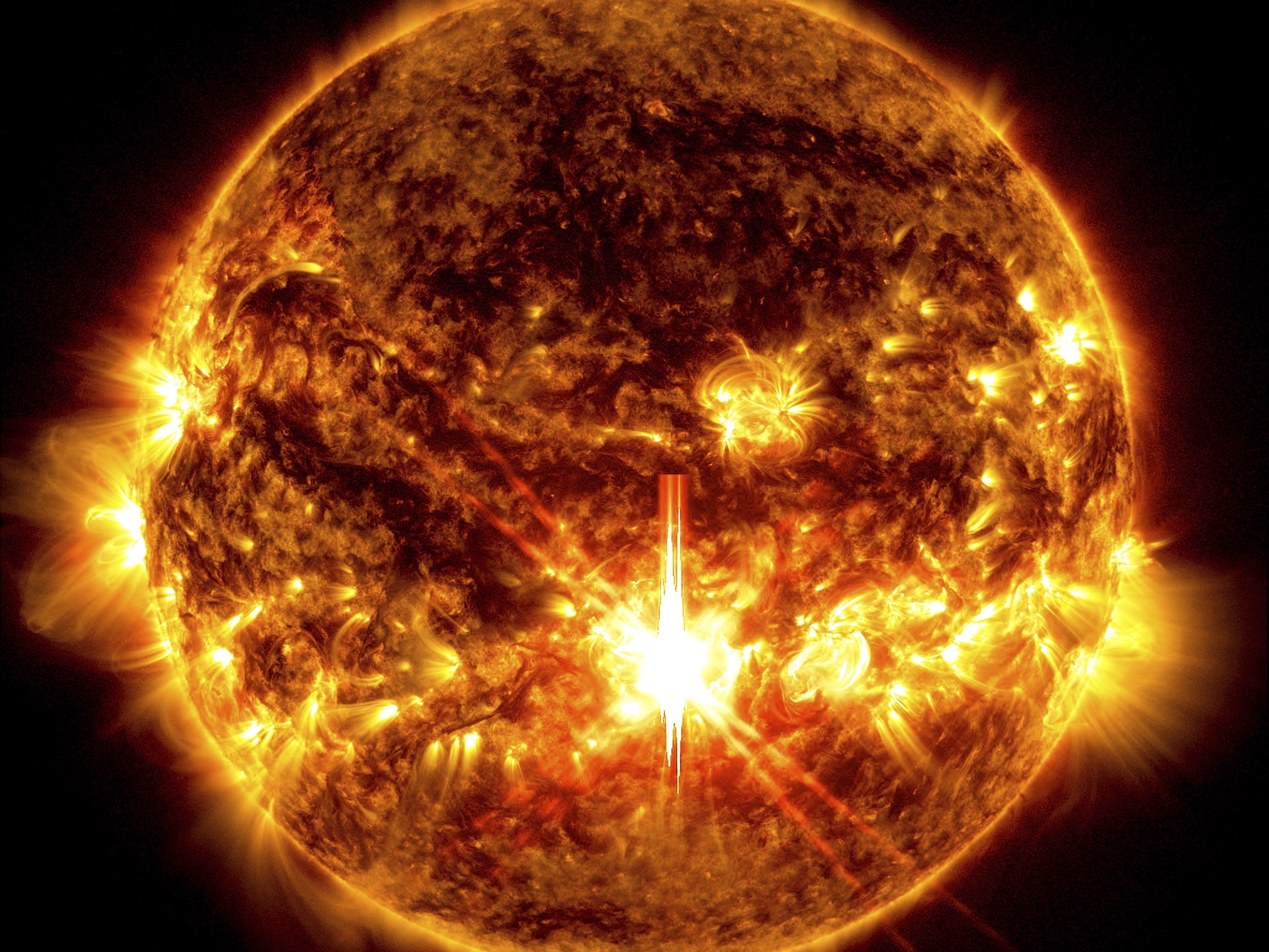 caption: This photo provided by NASA, taken by the Solar Dynamics Observatory, shows a solar flare, the bright flash in the center of the image on Oct. 3, 2024.