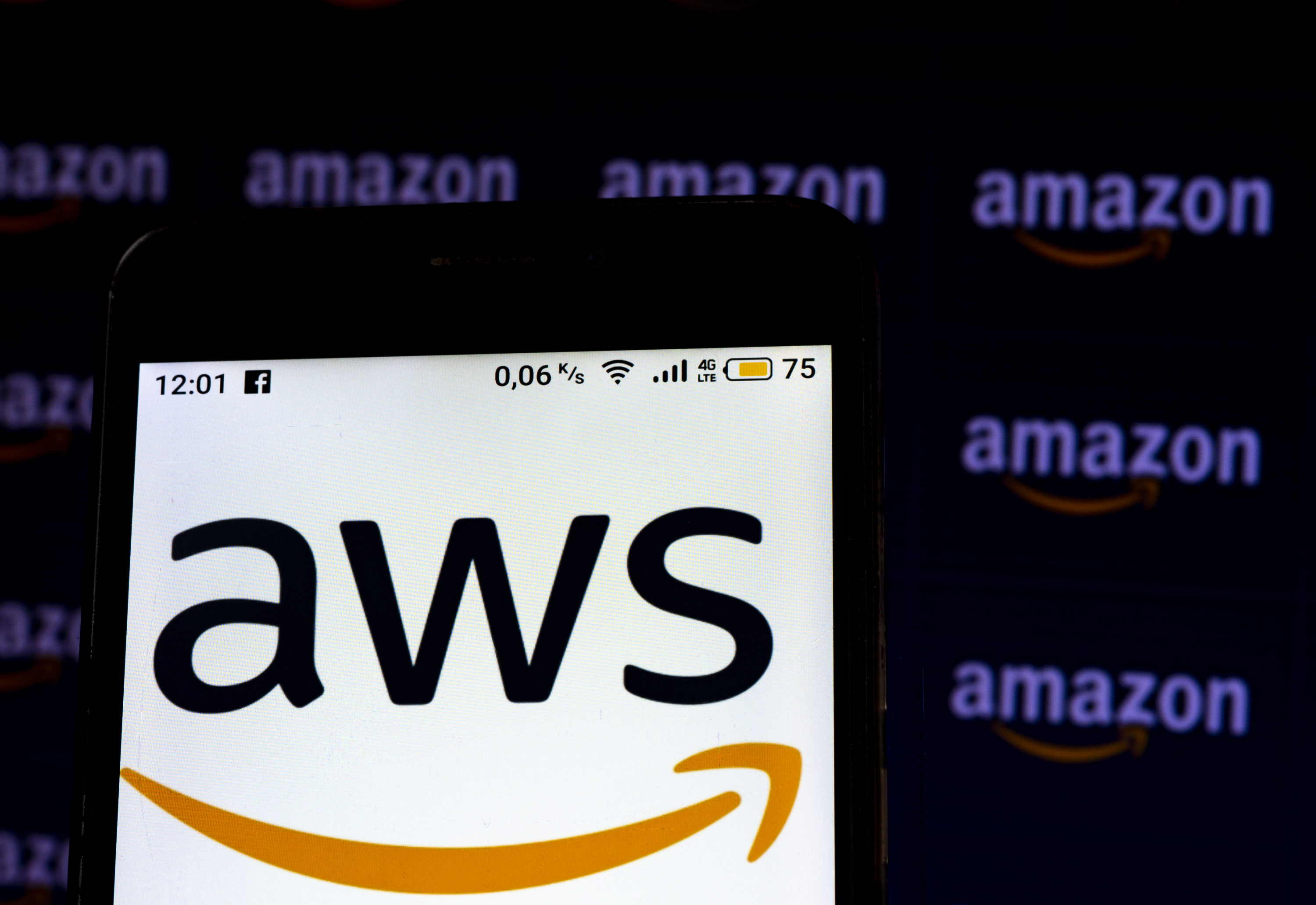 caption: An Amazon Web Services logo seen displayed on a smartphone screen. (Igor Golovniov/SOPA Images/LightRocket via Getty Images)