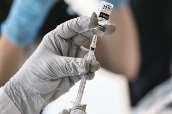 caption: Registered pharmacist Sapana Patel, loads a syringe with monkeypox vaccine at a pop-up vaccination site on Wednesday, Aug. 3, 2022, in West Hollywood, Calif.