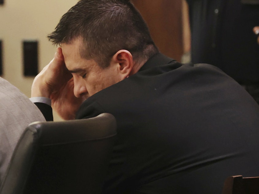 caption: Former U.S. Border Patrol supervisor Juan David Ortiz reacts as recorder jail phone calls to his wife, Daniella, are played outside the presence of the jury during his capital murder trial in San Antonio, Texas, Tuesday, Dec. 6, 2022