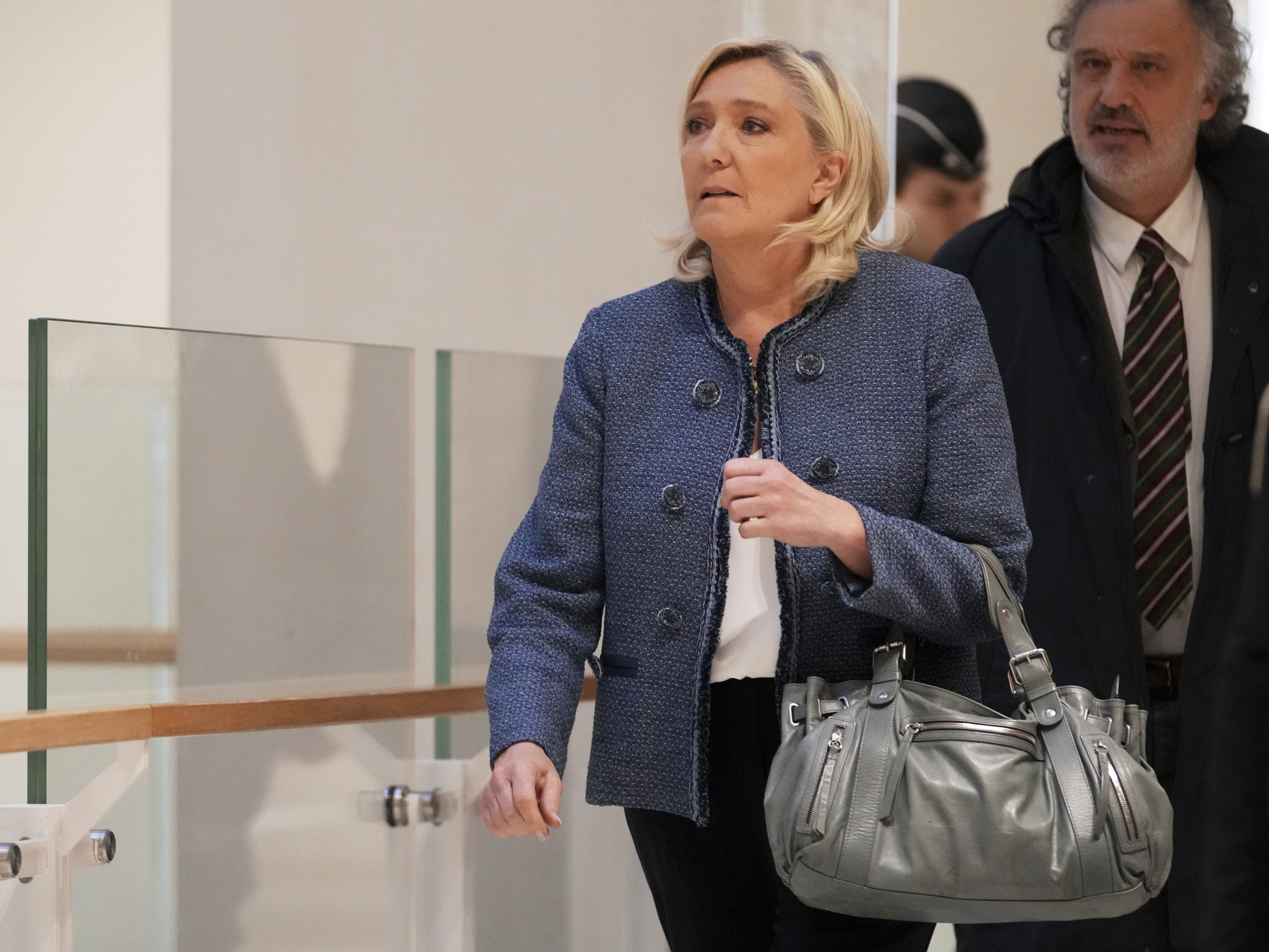 caption: French far-right leader Marine Le Pen arrives at a Paris court expected to deliver a verdict in an embezzlement case that could shake up French politics and derail far-right leader Marine Le Pen's career Monday, March 31, 2025 in Paris.