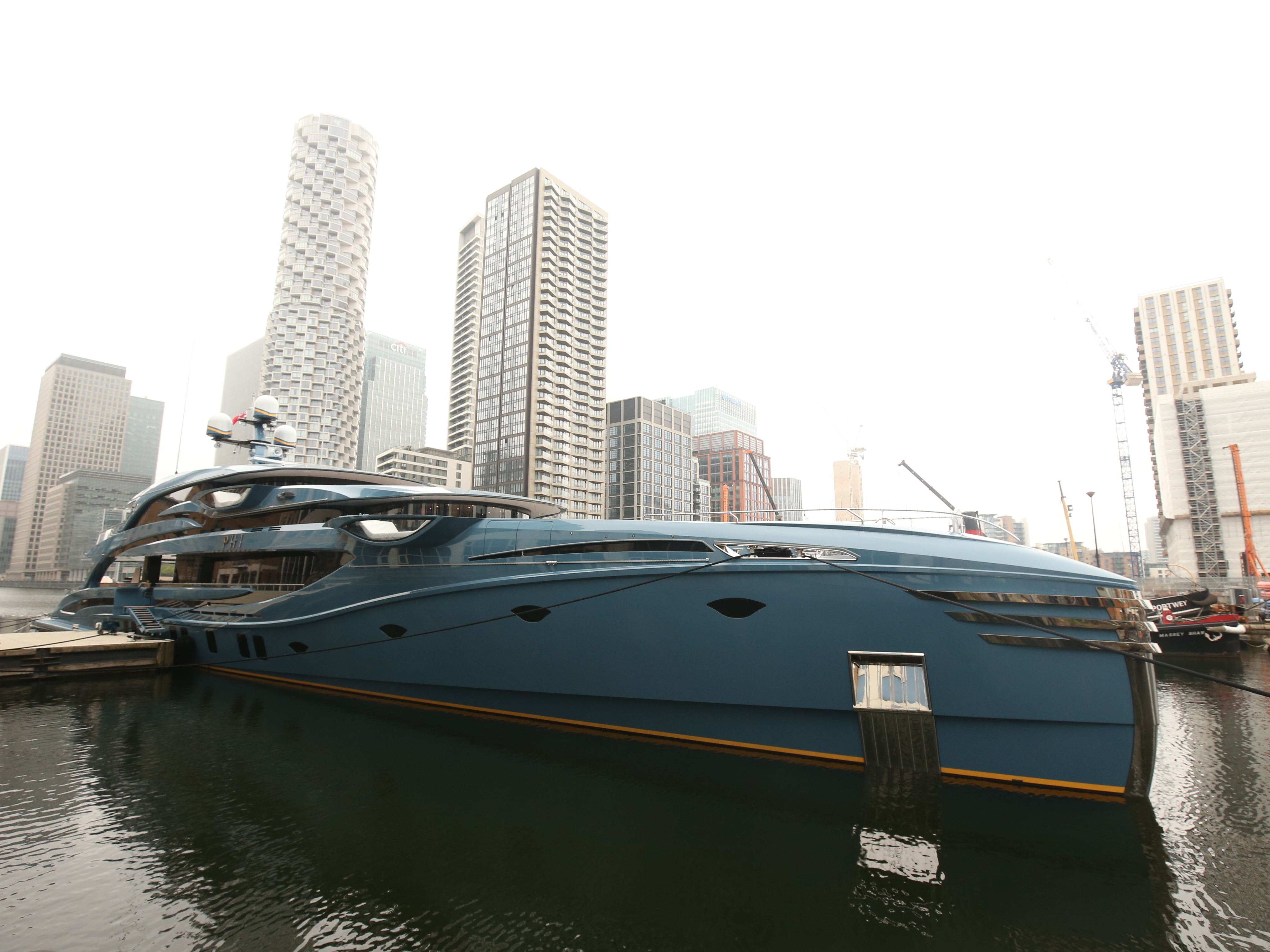 caption: The newly-detained superyacht Phi is pictured while docked in Canary Wharf in east London on Tuesday.