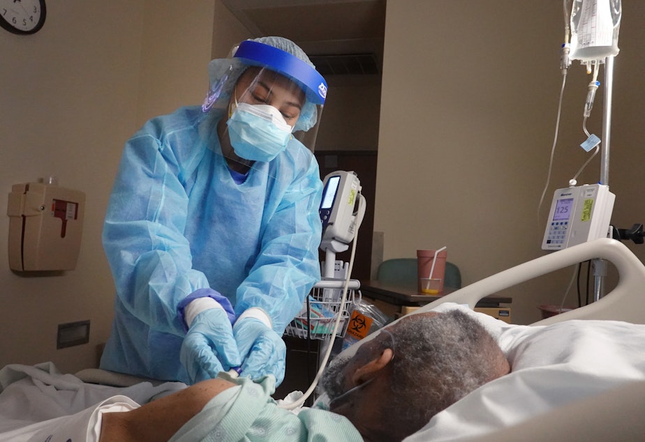 caption: The average rate of confirmed coronavirus cases fell below 100,000 for the first time since Nov. 4, but health experts warn that highly infectious virus variants pose a serious risk to that downward trend.