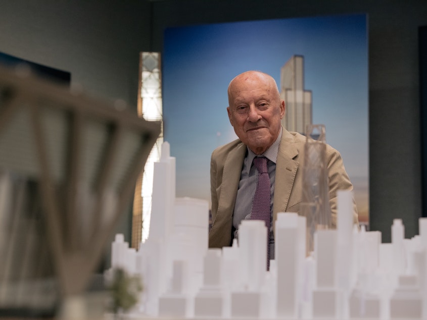 caption: Lord Norman Foster sits for a portrait on the 42nd floor of JPMorgan's current headquarters. Lord Foster is the architect for a new 60-story building the bank is building. He describes the new structure as a "a breathing building" because of the increased focus on air circulation.