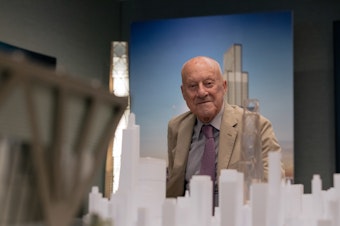 caption: Lord Norman Foster sits for a portrait on the 42nd floor of JPMorgan's current headquarters. Lord Foster is the architect for a new 60-story building the bank is building. He describes the new structure as a "a breathing building" because of the increased focus on air circulation.