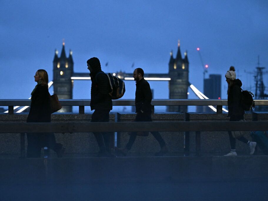 caption: Commuters cross London Bridge. Maybe some of them have a four-day workweek.