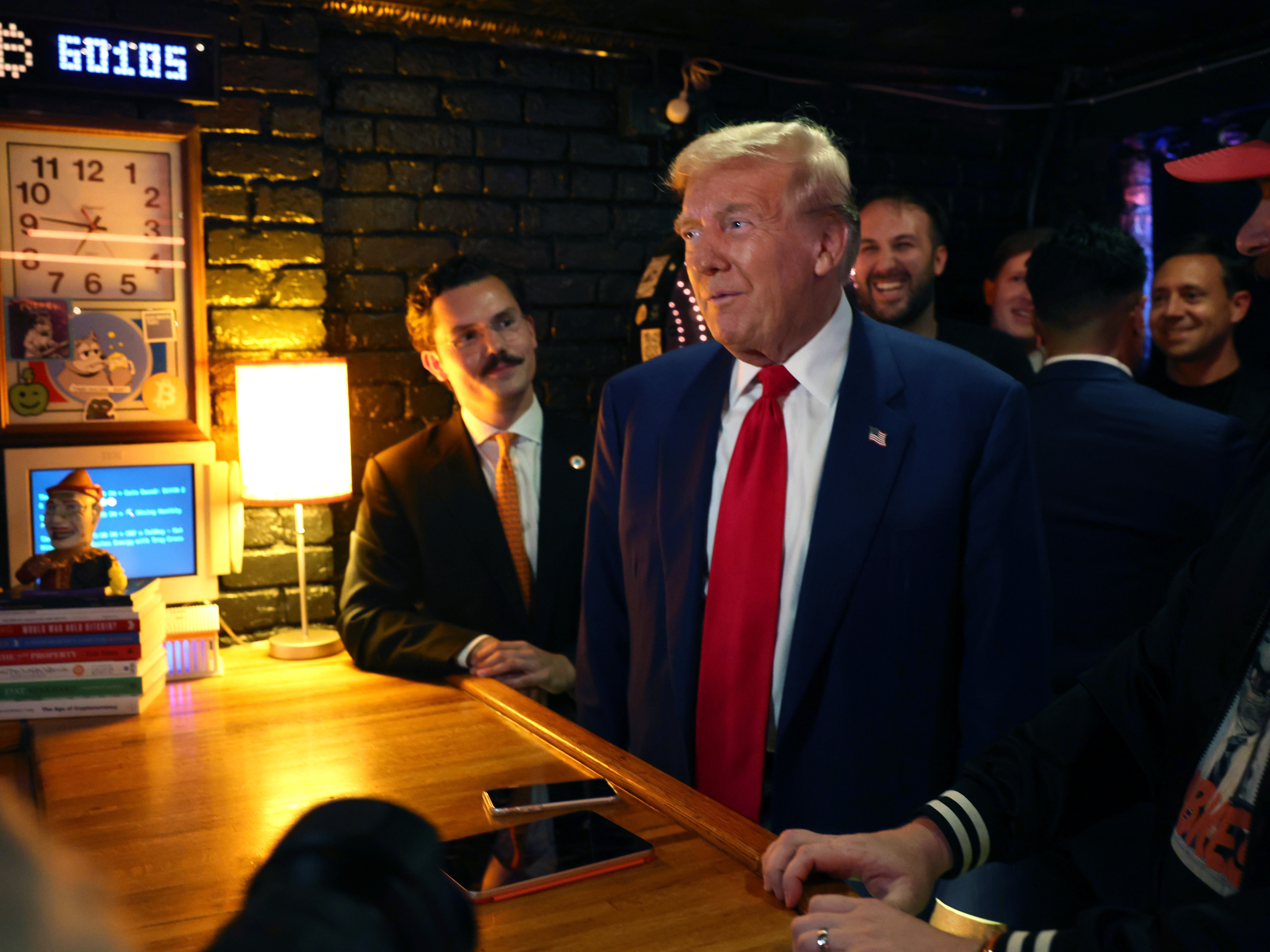 caption: President Trump embraced cryptocurrency during his campaign, including during this visit to a cryptocurrency-themed bar called Pubkey in New York City on Sept. 18.