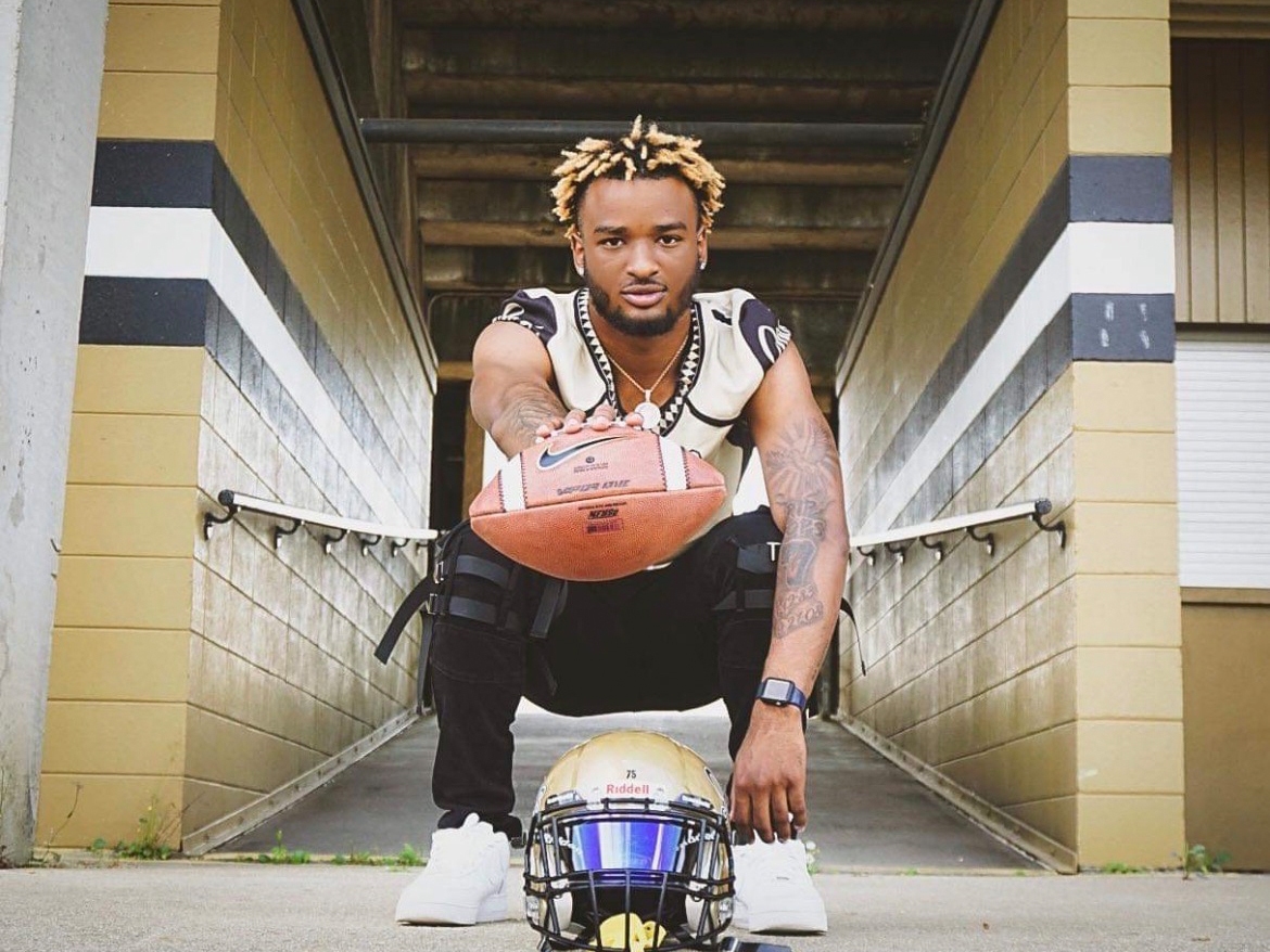 caption: Tajdryn Forbes died at 19. He was the glue of his family, mother Naketra Guy said. She called him "humble" and "respectful," a leader in the community and on the football field, where he shined.