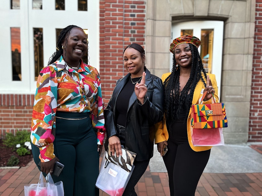 caption: Monika Thornton Lawrence, owner of Powerful Beginnings, Meisha Russell, owner of online clothier Murch Ave, and Ruzeda Fields, who sells clothes made from Kitenge fabric, are among the business owners who attended a Black Wall Street themed event in Seattle in May 2024.