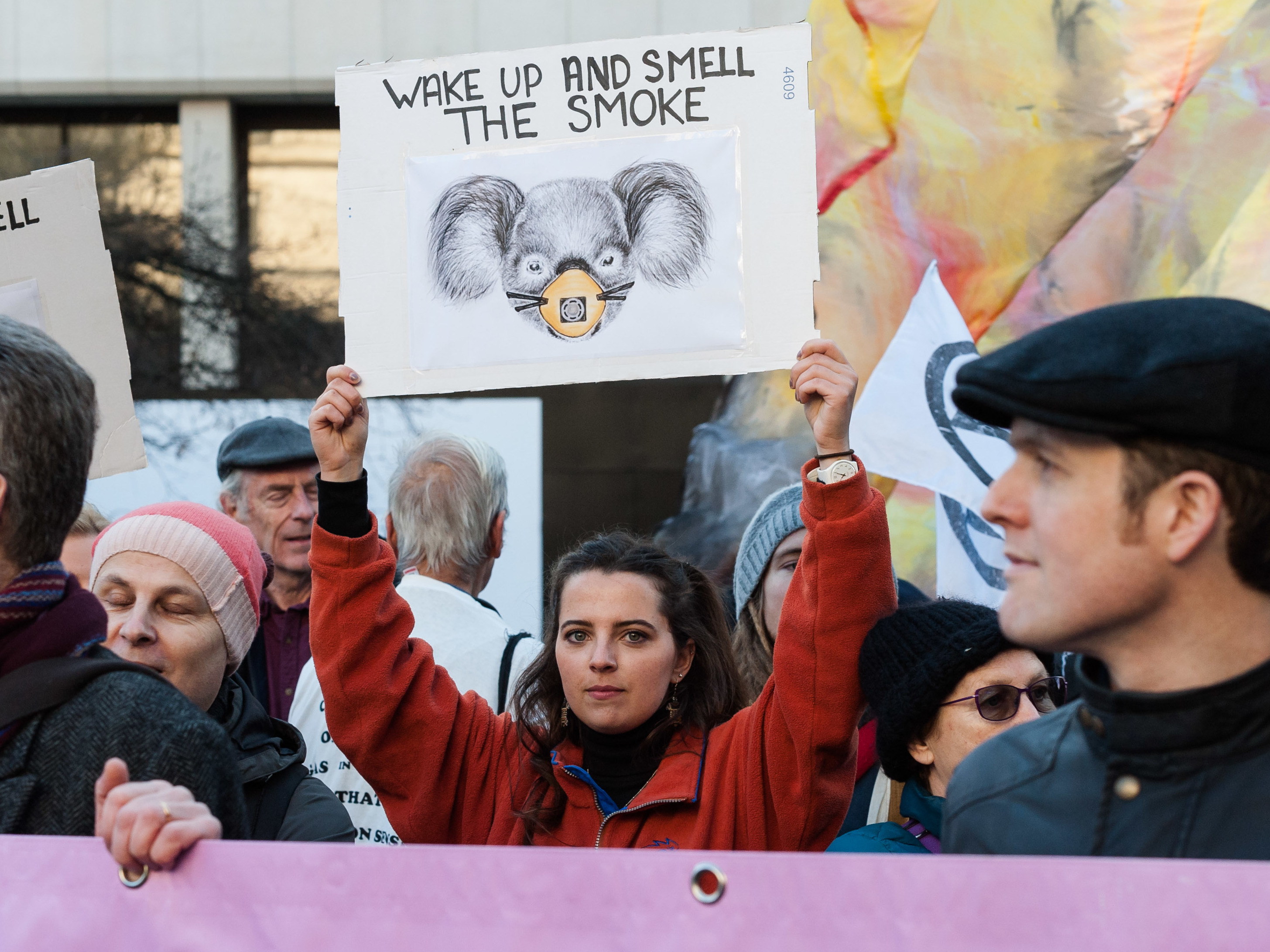 caption: Australia's unprecedented wildfires are the subject of several hoaxes – including reports that emphasize the role of arson as the chief cause for their devastating impact.  Here, activists from Extinction Rebellion protest outside the Australian Embassy in London, accusing Australia's government of inadequately responding to the fires and an overall climate emergency.