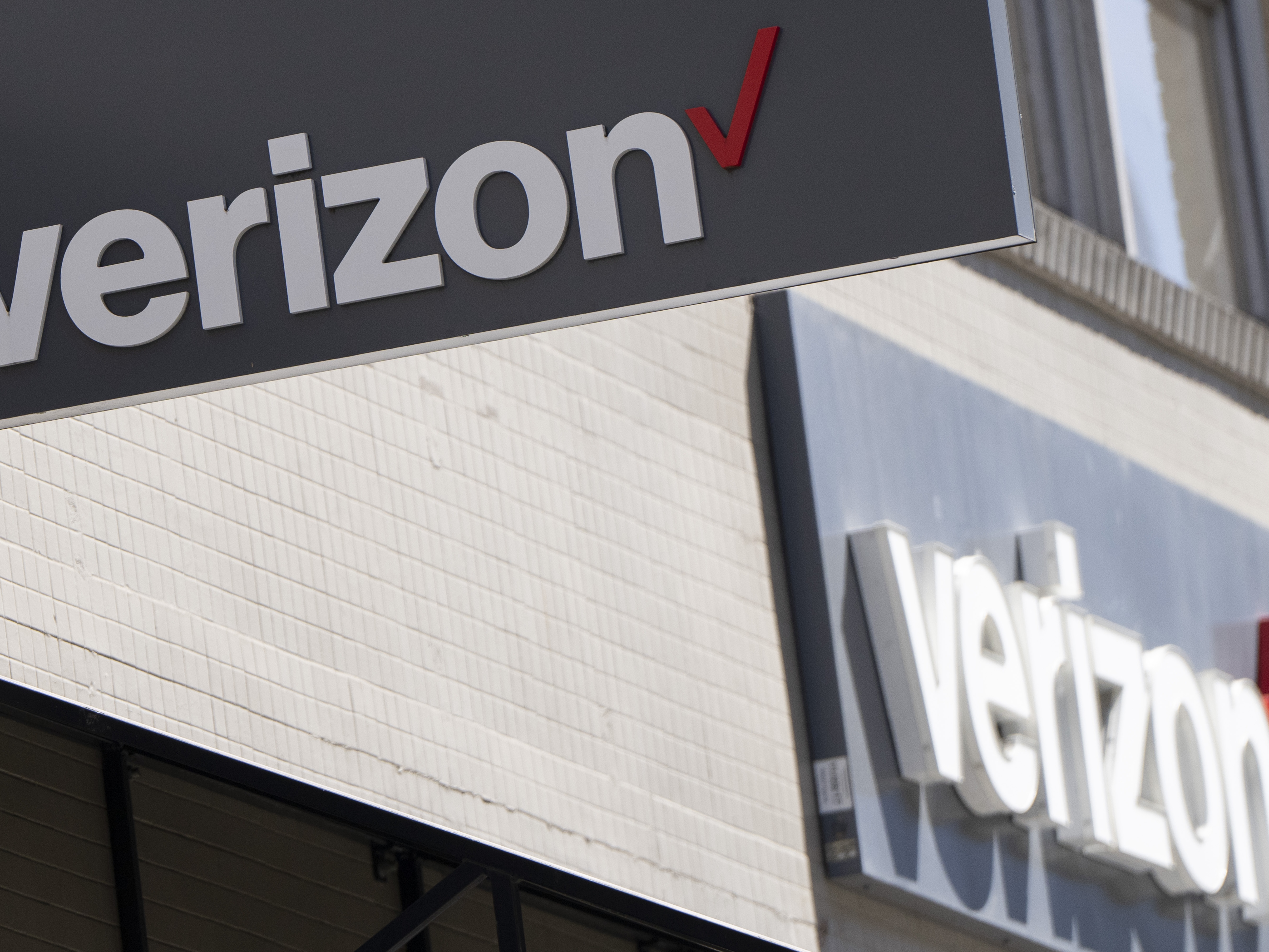 caption: Signs are displayed outside a Verizon retail location on May 14, 2024, in Portland, Ore.