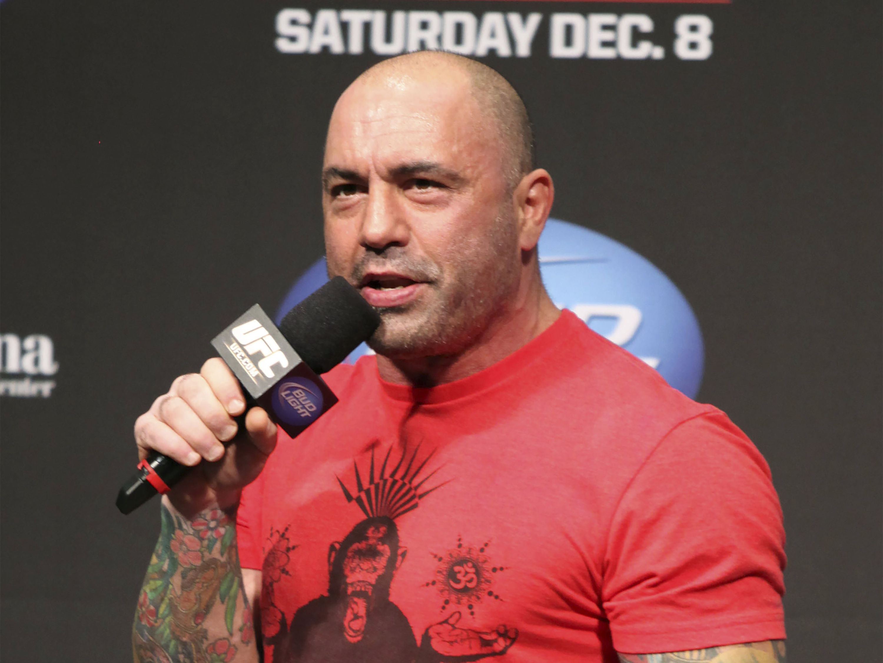 caption: UFC announcer and podcaster Joe Rogan speaks at the weigh in before a UFC on FOX 5 event in Seattle, on Dec. 7, 2012.