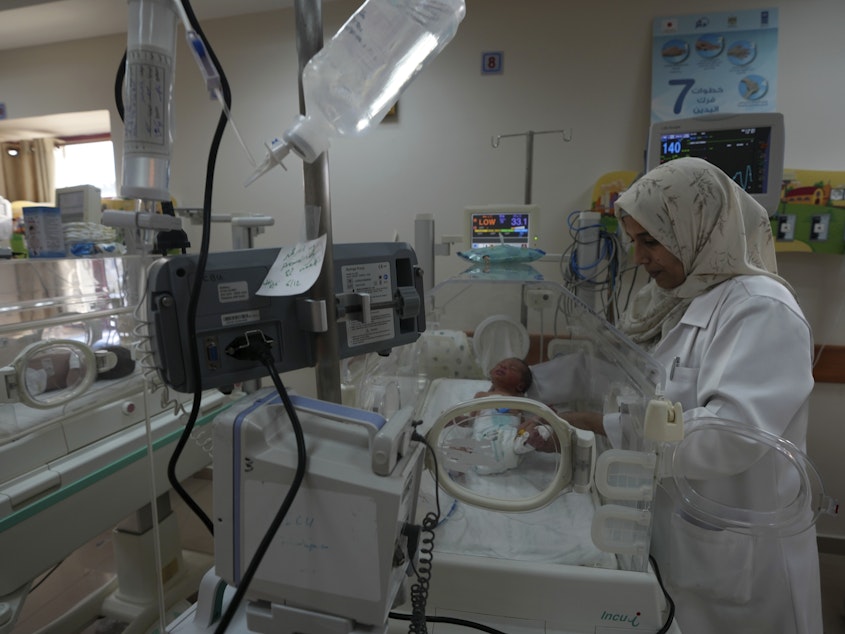 caption: A Palestinian doctor treats a prematurely born baby at Al Aqsa Hospital in Gaza on Sunday, Dec. 10, 2023.