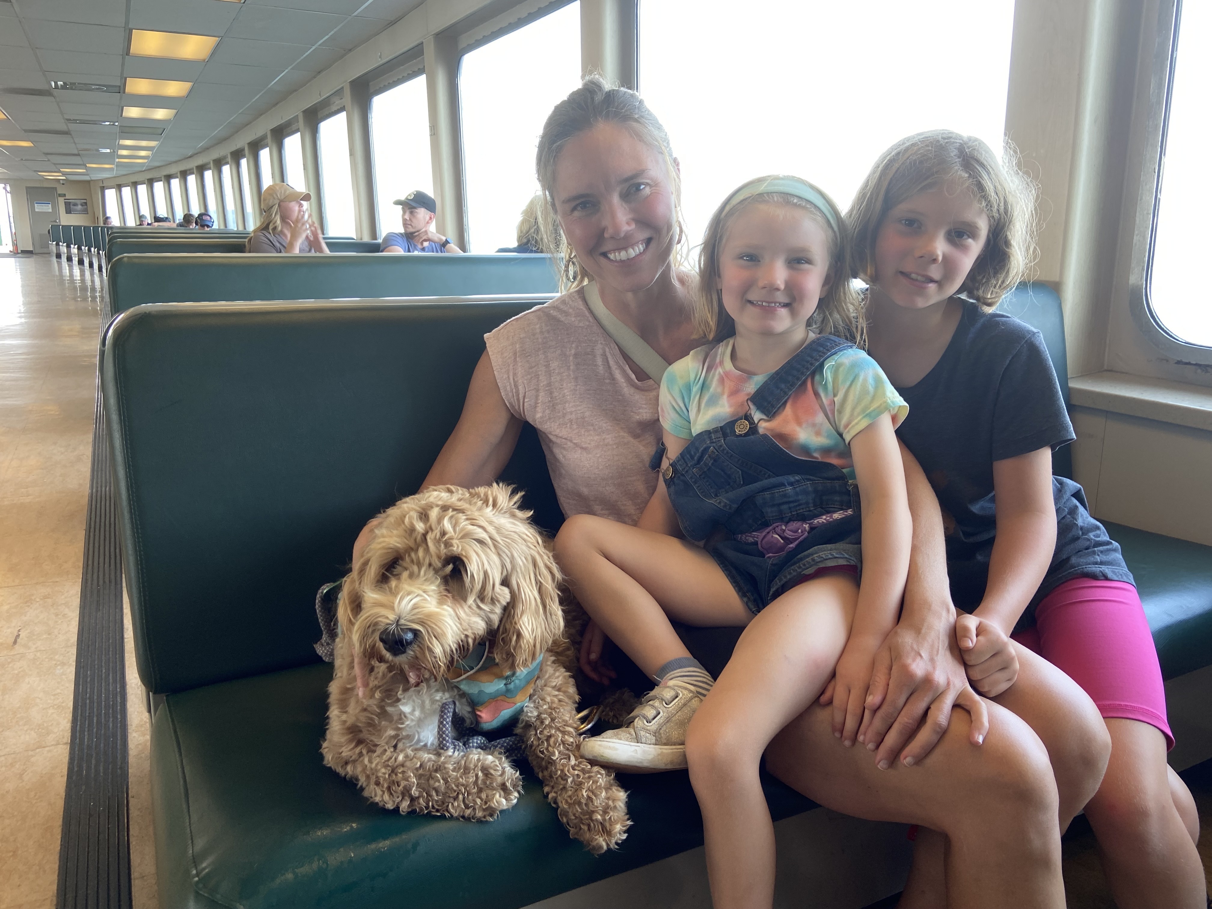 caption: Bridget Igoe (left) travels with her daughters Julia (center) and Helen (right) with their dog Juniper from Bainbridge to Seattle aboard the Walla Walla passenger ferry. 
