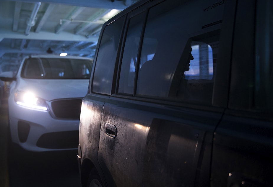 caption: Hope Black breathes through a contraction in the back seat of their vehicle while on the ferry en route to the hospital from Vashon Island, at 8:34 p.m. on Friday, May 28, 2020, in Seattle.