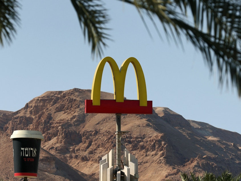 caption: A McDonald's restaurant's iconic "golden arches" logo next to a giant coffee cup of its "Aroma" trademark in the Israeli Dead Sea resort town of Ein Bokek.