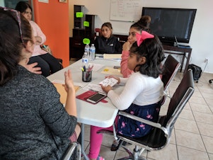 caption: Rocio Arriaga teaches kids and young people about business to try and mitigate the impacts of gentrification.
