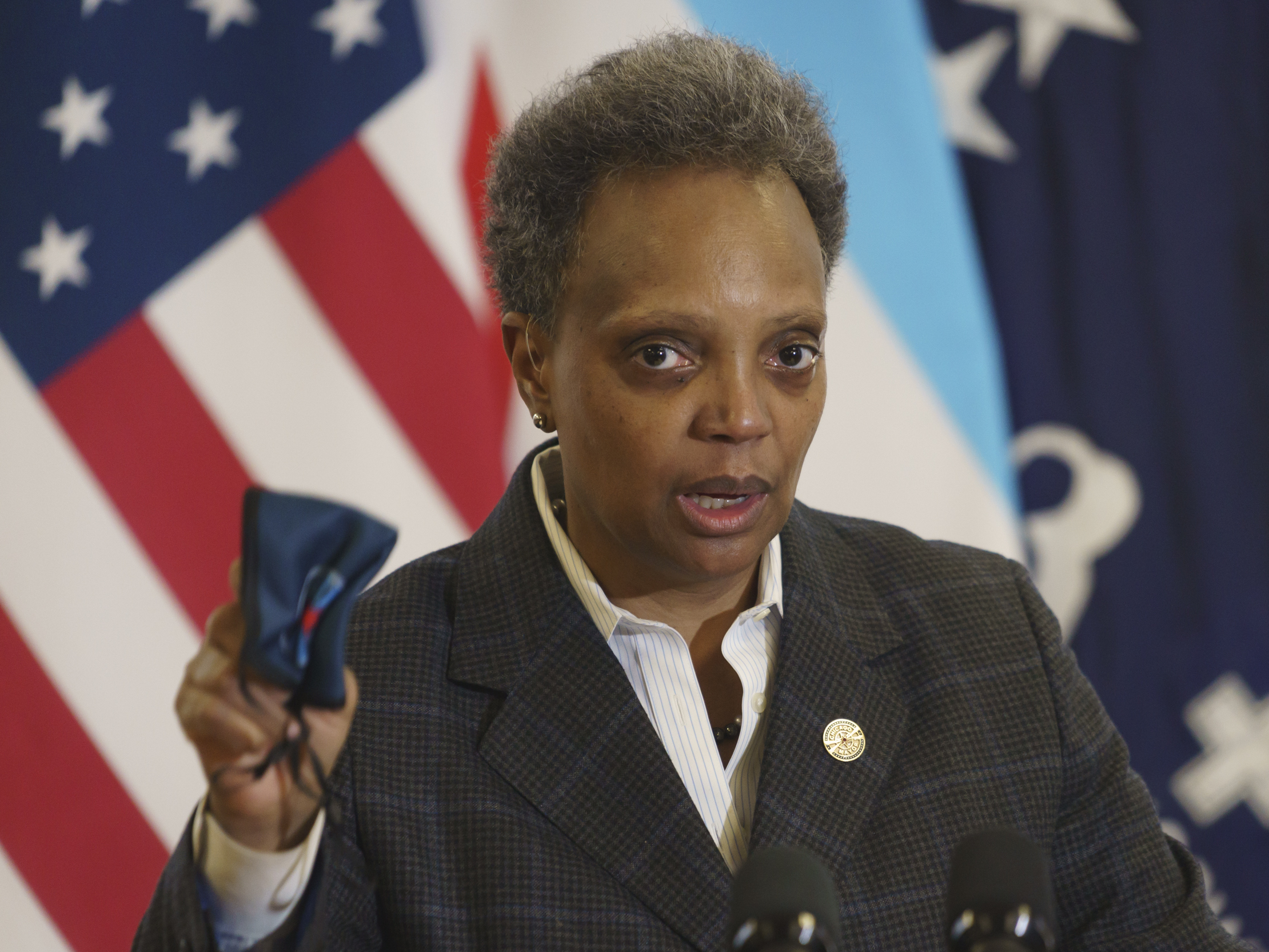 caption: Mayor Lori Lightfoot emphasizes the importance of wearing a mask as she provides an update about the COVID-19 vaccinations at Norwegian American Hospital in Chicago on Tuesday, Jan. 5, 2021.