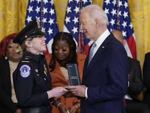 caption: President Biden awards the Presidential Citizens Medal, the nation's second-highest civilian honor, to U.S. Capitol Police officer Caroline Edwards during a ceremony to mark the second anniversary of the Jan. 6 assault on the Capitol in the East Room of the White House on Friday.