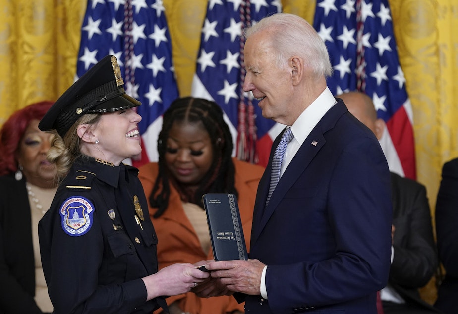 caption: President Biden awards the Presidential Citizens Medal, the nation's second-highest civilian honor, to U.S. Capitol Police officer Caroline Edwards during a ceremony to mark the second anniversary of the Jan. 6 assault on the Capitol in the East Room of the White House on Friday.