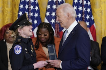 caption: President Biden awards the Presidential Citizens Medal, the nation's second-highest civilian honor, to U.S. Capitol Police officer Caroline Edwards during a ceremony to mark the second anniversary of the Jan. 6 assault on the Capitol in the East Room of the White House on Friday.