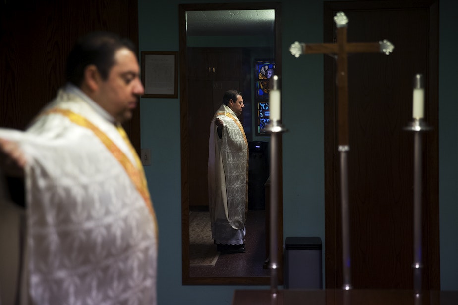 caption: Father Jose Alvarez gets ready for a live-streamed daily mass in Spanish on Friday, April 24, 2020, at Holy Family Roman Catholic Church in White Center.