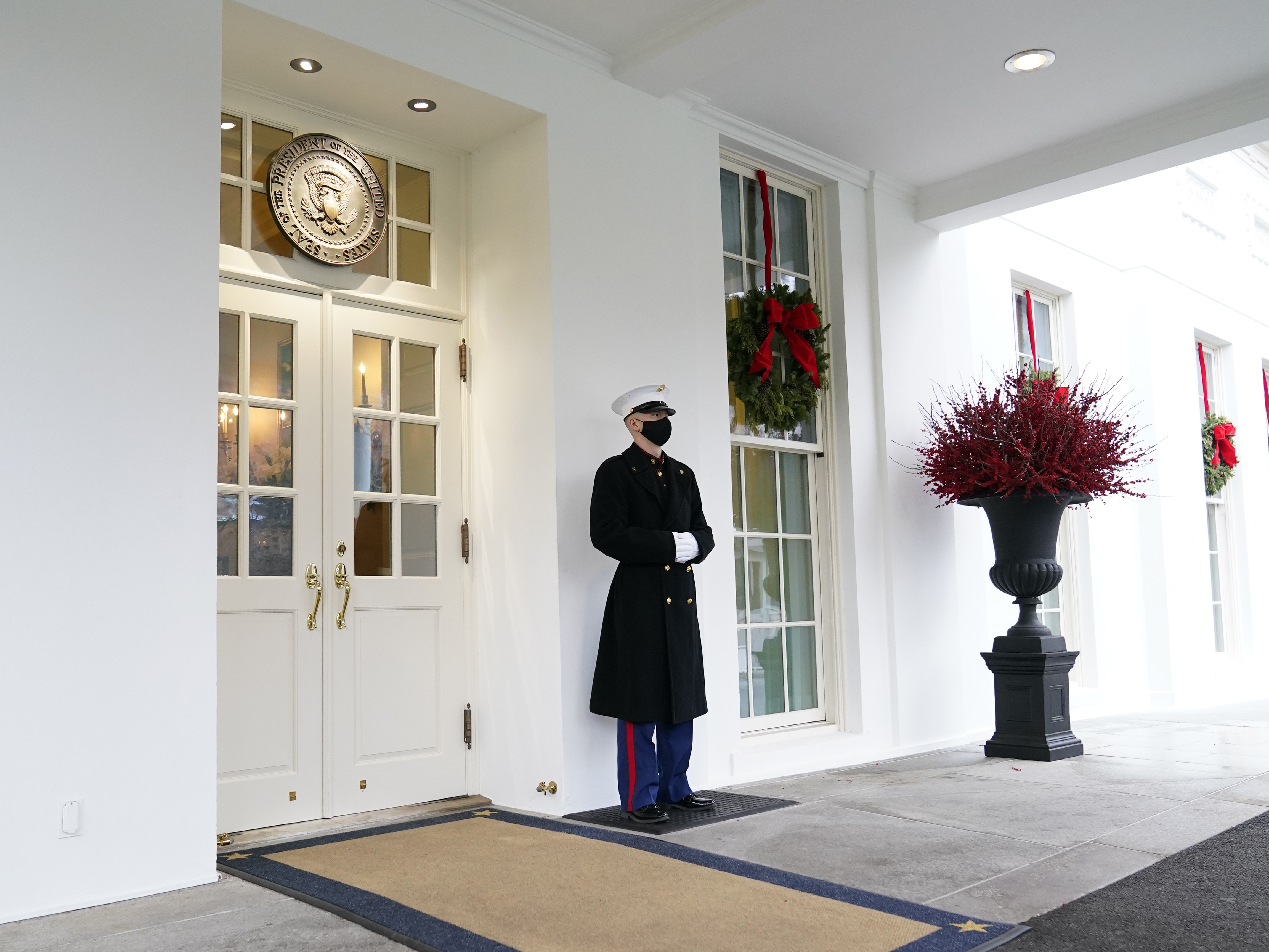 caption: A marine stands outside the West Wing of the White House earlier this week. President Trump has been lobbied by advocates to use his powers to grant pardons and commutations ahead of leaving office.
