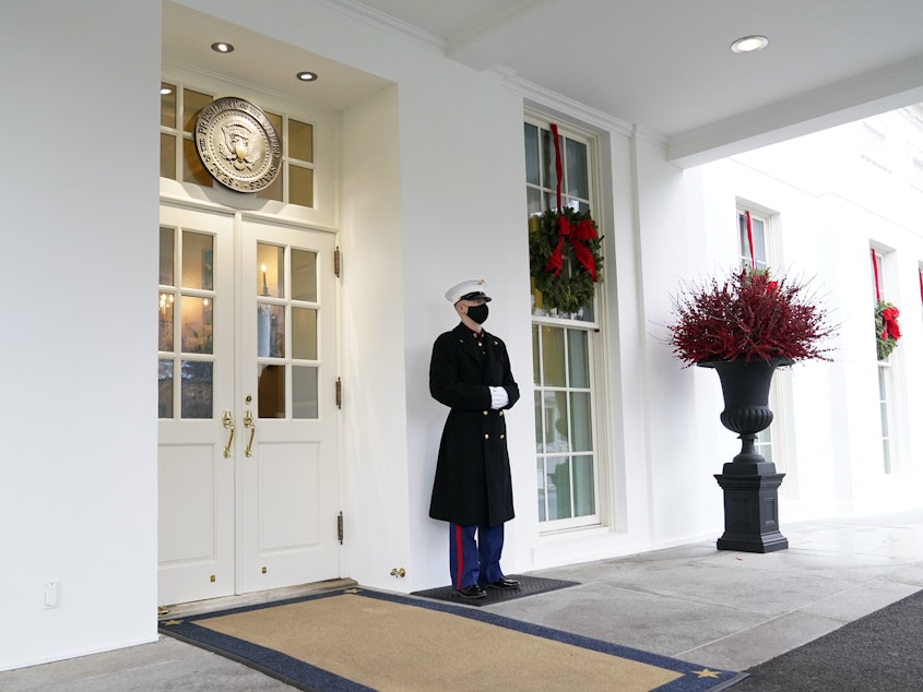 caption: A marine stands outside the West Wing of the White House earlier this week. President Trump has been lobbied by advocates to use his powers to grant pardons and commutations ahead of leaving office.