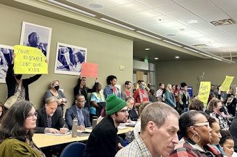 caption: Dozens of parents and teachers flooded the Seattle School Board meeting Oct. 11, decrying widespread classroom shuffles at over half of the district's schools.