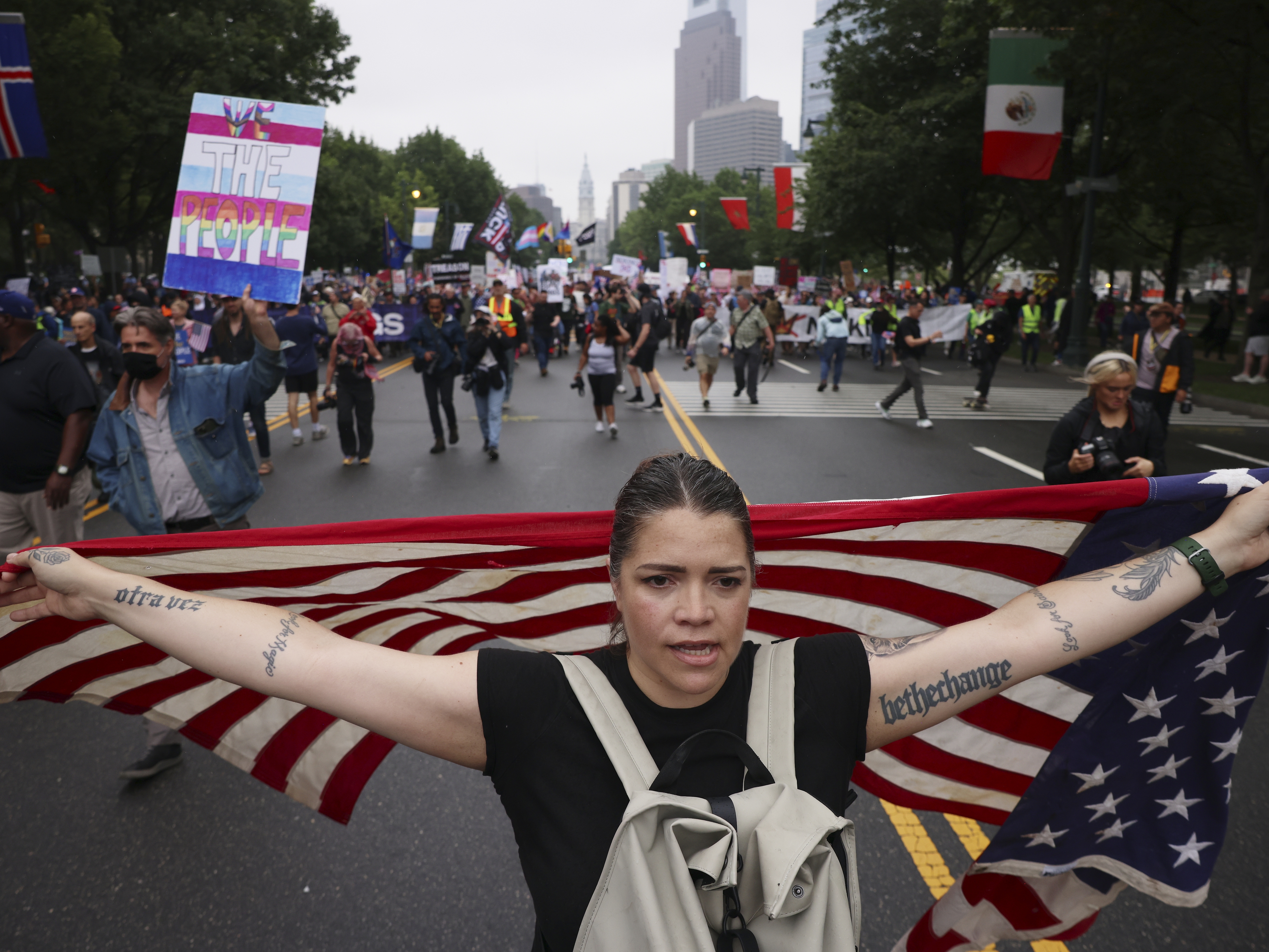 caption: Demonstrators march down Benjamin Franklin Parkway during the No Kings protest, Saturday, June 14, 2025, in Philadelphia.