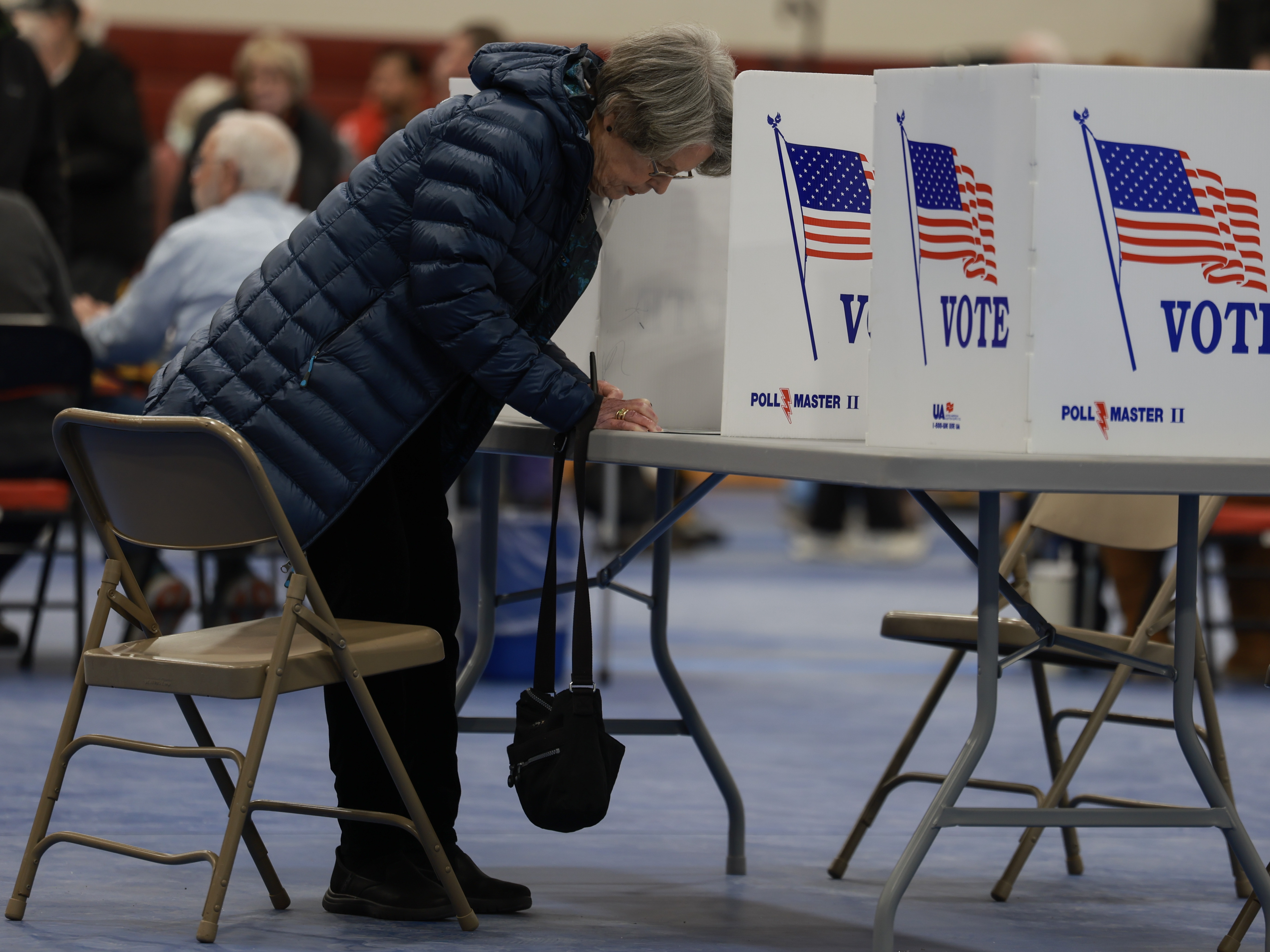 caption: A voter fills out their New Hampshire presidential primary ballot at a polling location in Bedford on Jan. 23.