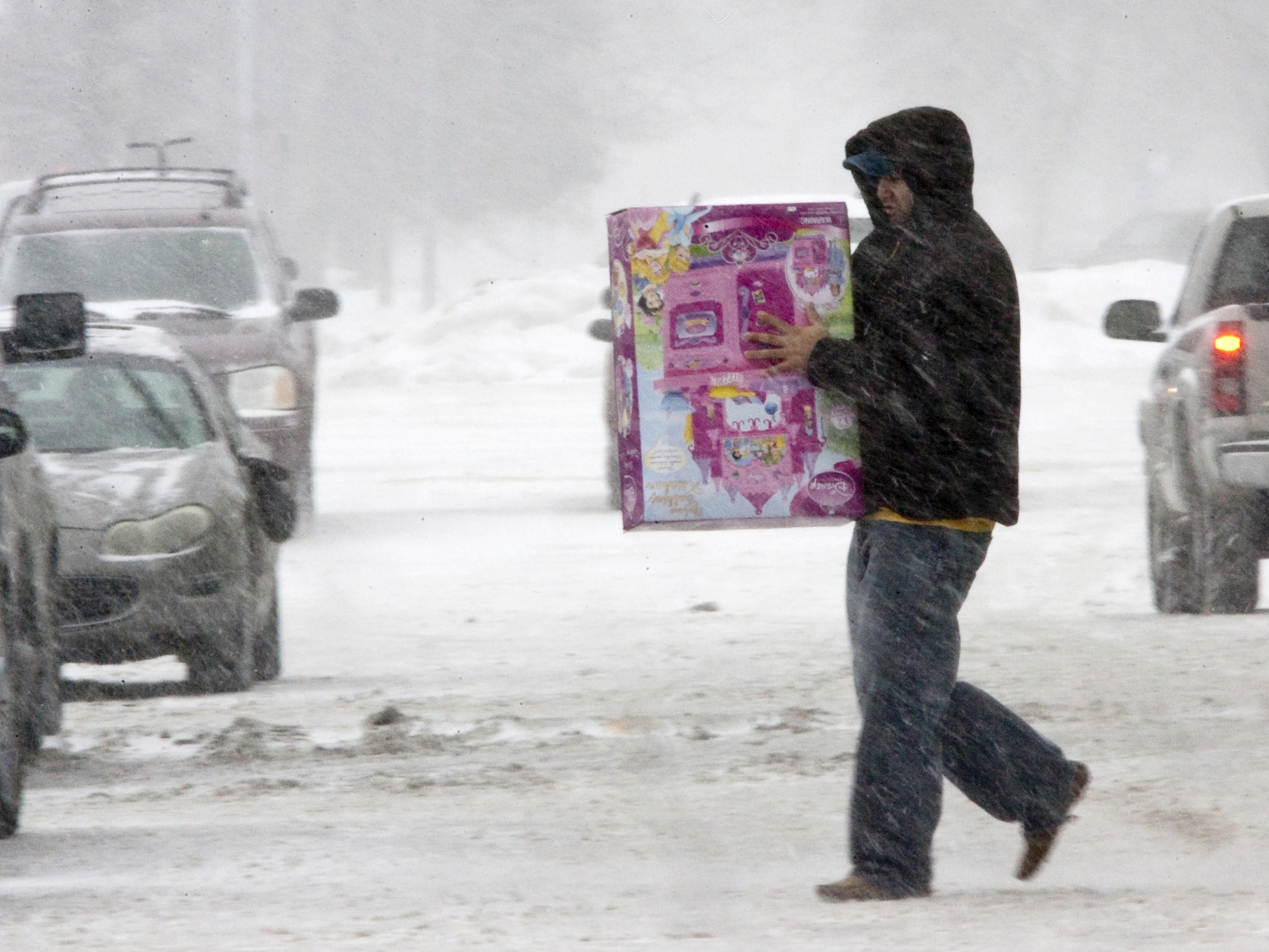 caption: An unidentified person braves the weather to do last-minute shopping on Christmas Eve in Omaha, Neb., on Dec. 24, 2009. That year, a powerful storm spread snow, sleet and rain across the nation's midsection.