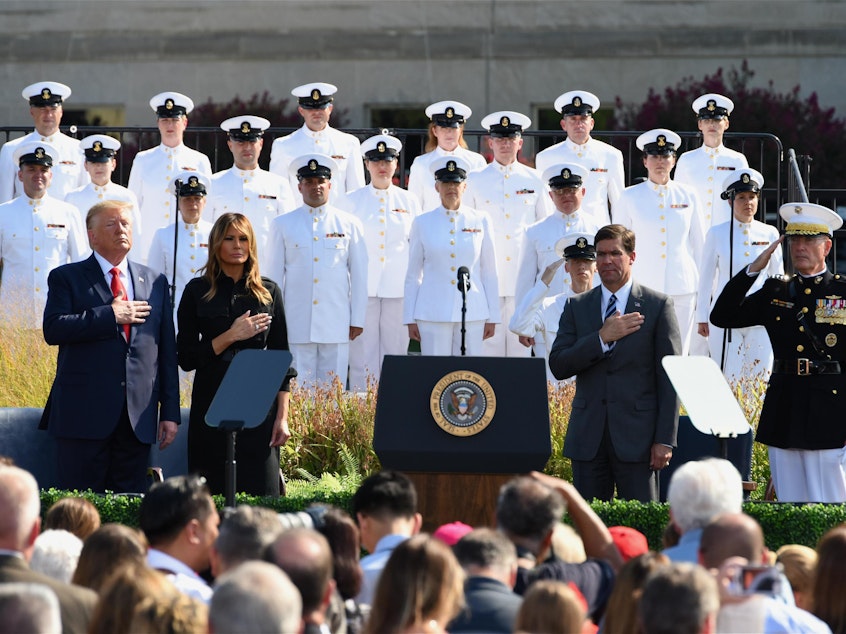 caption: President Trump and first lady Melania Trump listen to the national anthem during a ceremony marking the 18th anniversary of the Sept. 11 attacks at the Pentagon earlier this week.