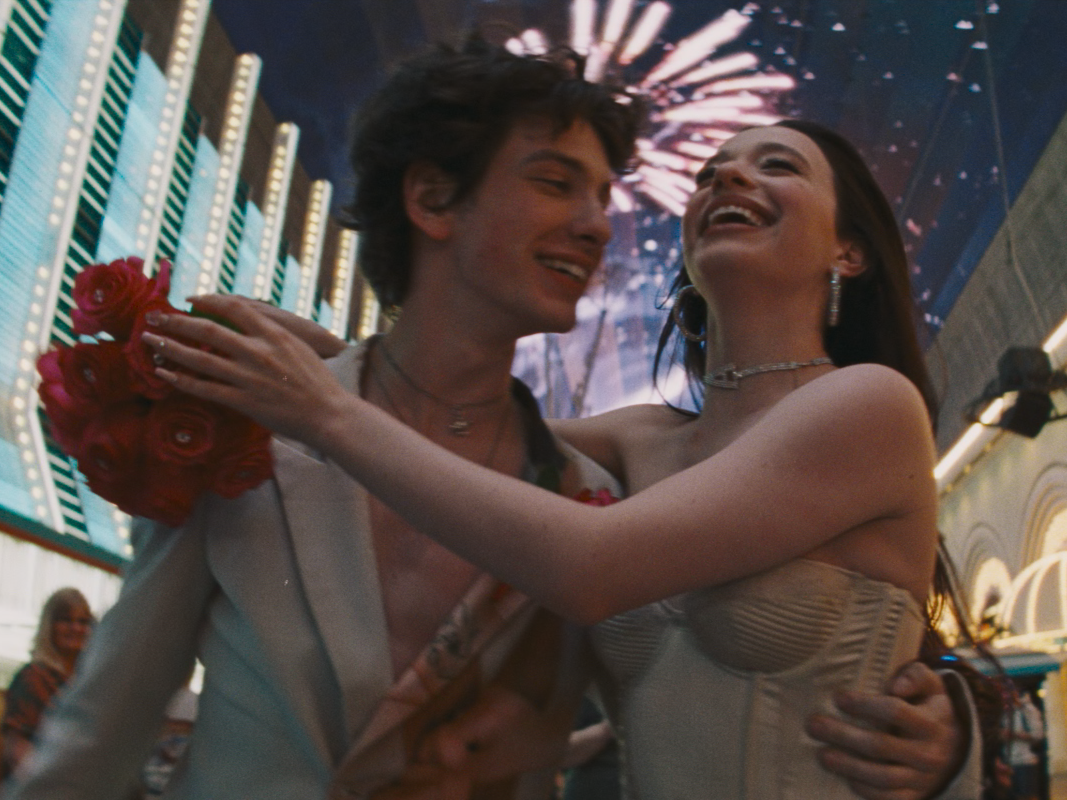 caption: Ani (Mikey Madison) is an exotic dancer who gets more than she bargained for when she marries the son of a Russian oligarch (Mark Eydelshteyn) in <em>Anora.</em>