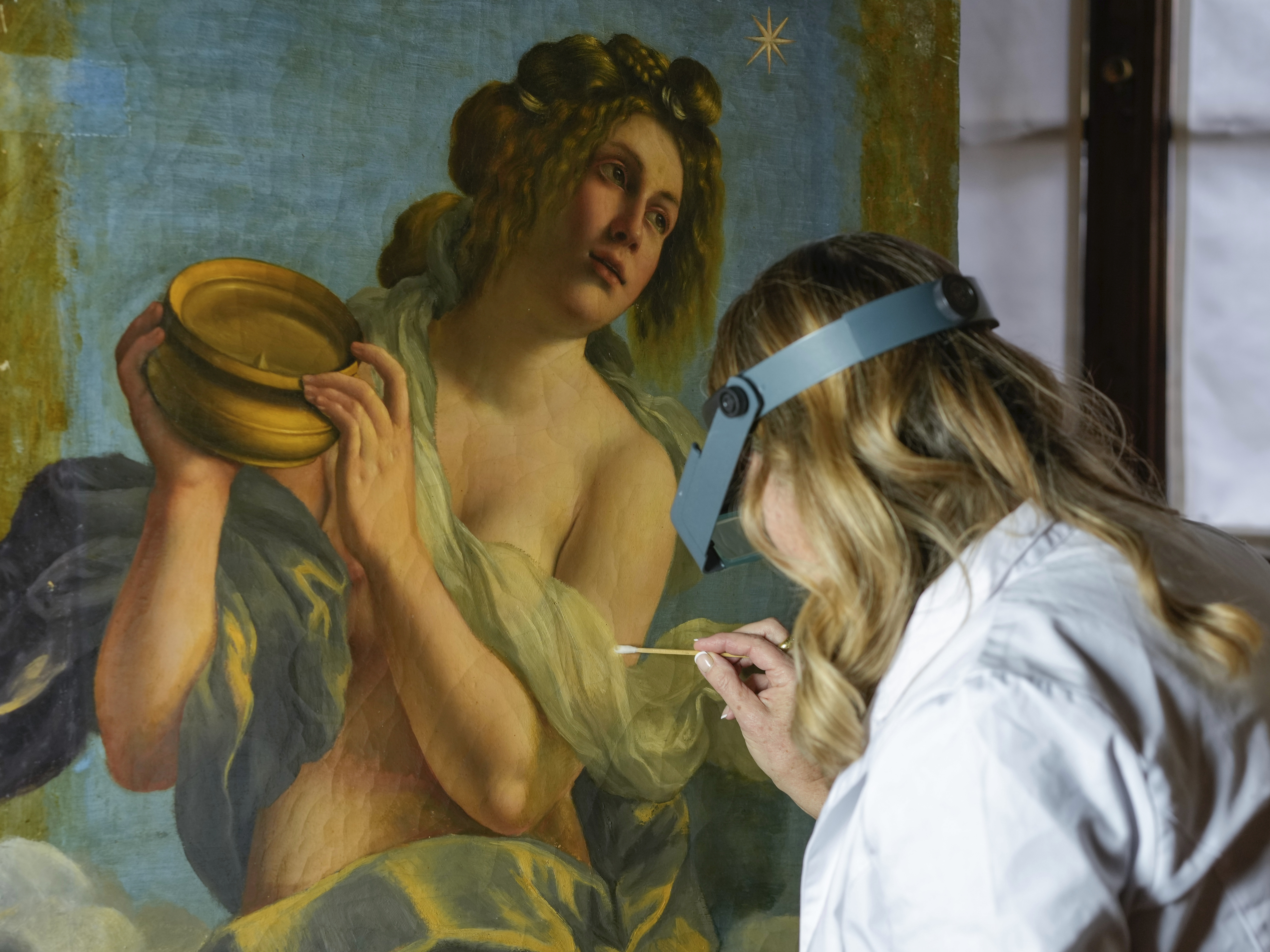 caption: Restorer Elizabeth Wicks works on the <em>Allegory of Inclination</em>, a 1616 work by Artemisia Gentileschi, in the Casa Buonarroti Museum, in Florence, Italy, on Wednesday.