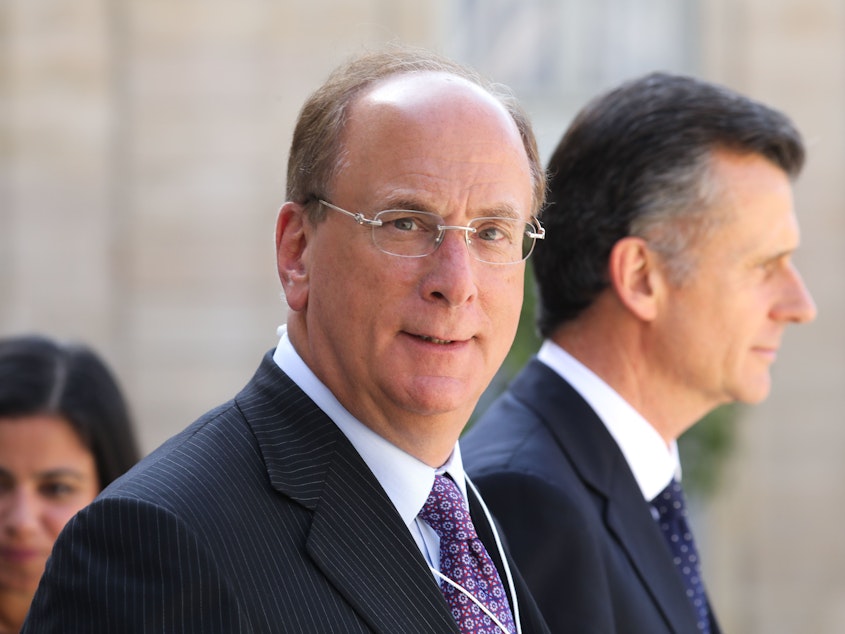 caption: BlackRock Chairman and CEO Larry Fink, seen here in Paris in July, wrote in his annual letter to CEOs that climate change will soon cause "a significant reallocation of capital."